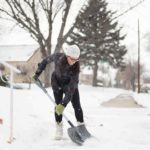 woman shoveling snow