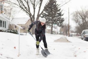 woman shoveling snow